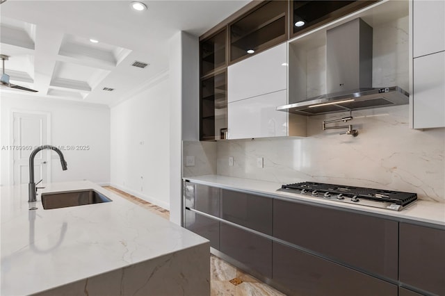 260 NE Wavecrest Ct, Boca Raton, FL 33432 - kitchen with wall chimney exhaust hood, modern cabinets, stainless steel gas cooktop, crown molding, and decorative backsplash