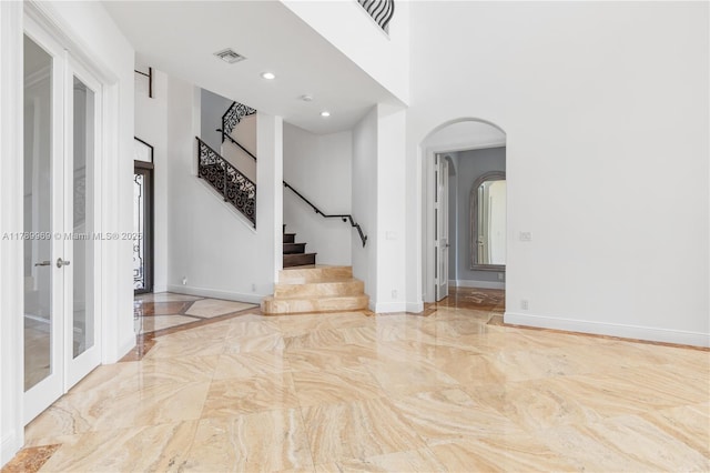 260 NE Wavecrest Ct, Boca Raton, FL 33432 - entryway with arched walkways, marble tiled floors, a high ceiling, stairs, and recessed lighting