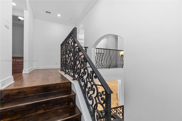 260 NE Wavecrest Ct, Boca Raton, FL 33432 - staircase with hardwood / wood-style flooring, crown molding, arched walkways, and recessed lighting