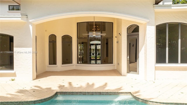 260 NE Wavecrest Ct, Boca Raton, FL 33432 - property entrance with stucco siding and an outdoor pool