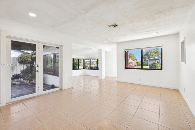 6451 Coolidge St, Hollywood, FL 33024 - empty room with visible vents, baseboards, recessed lighting, french doors, and light tile patterned floors