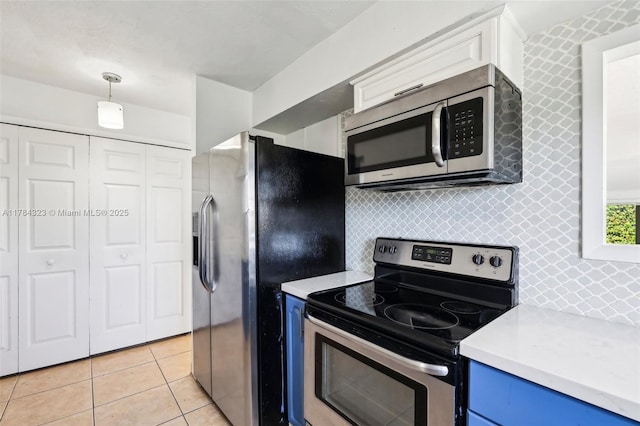 6451 Coolidge St, Hollywood, FL 33024 - kitchen featuring backsplash, blue cabinets, appliances with stainless steel finishes, light countertops, and light tile patterned floors