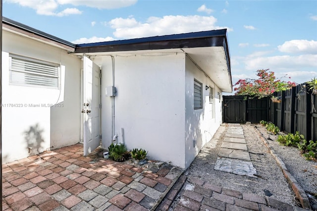 6451 Coolidge St, Hollywood, FL 33024 - view of home's exterior with fence, a patio area, and stucco siding