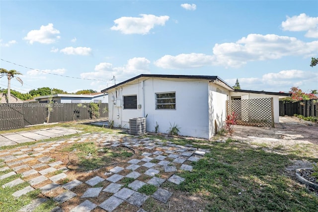 6451 Coolidge St, Hollywood, FL 33024 - back of property with central air condition unit, fence, a patio area, and stucco siding