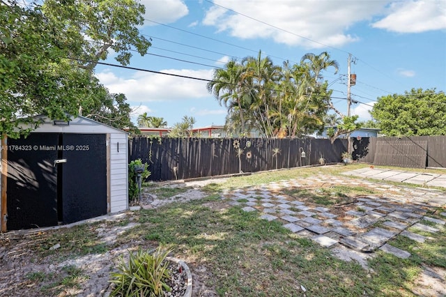 6451 Coolidge St, Hollywood, FL 33024 - view of yard with a patio, a fenced backyard, a shed, and an outbuilding