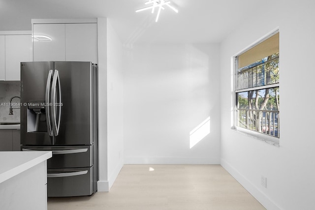 13000 SW 15th Ct Unit 310U, Pembroke Pines, FL 33027 - kitchen with light wood-style flooring, baseboards, modern cabinets, white cabinetry, and stainless steel refrigerator with ice dispenser