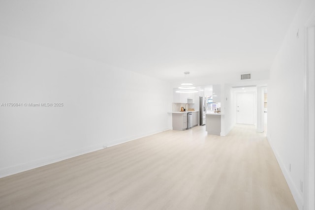 13000 SW 15th Ct Unit 310U, Pembroke Pines, FL 33027 - unfurnished living room featuring light wood-type flooring, visible vents, and baseboards