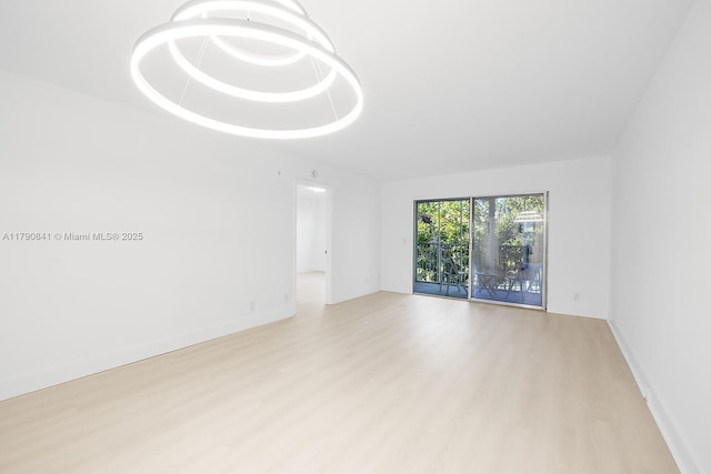 13000 SW 15th Ct Unit 310U, Pembroke Pines, FL 33027 - spare room featuring baseboards and wood finished floors