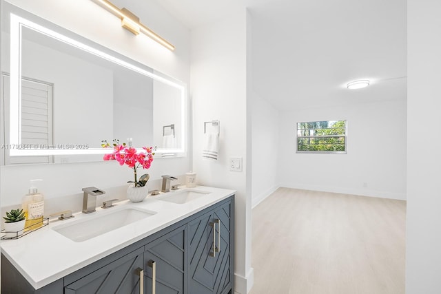 13000 SW 15th Ct Unit 310U, Pembroke Pines, FL 33027 - bathroom with a sink, double vanity, baseboards, and wood finished floors