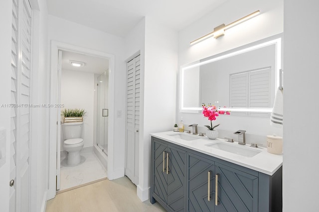 13000 SW 15th Ct Unit 310U, Pembroke Pines, FL 33027 - bathroom featuring a sink, toilet, a closet, and wood finished floors