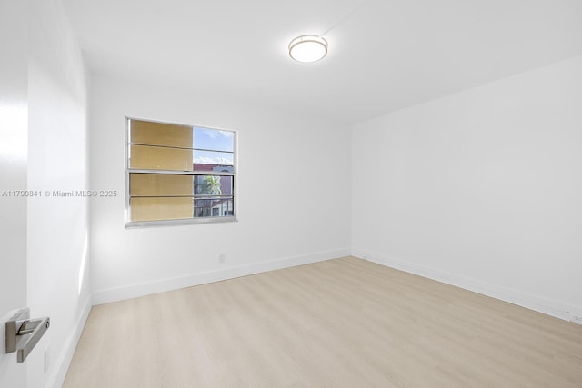 13000 SW 15th Ct Unit 310U, Pembroke Pines, FL 33027 - spare room featuring baseboards and wood finished floors