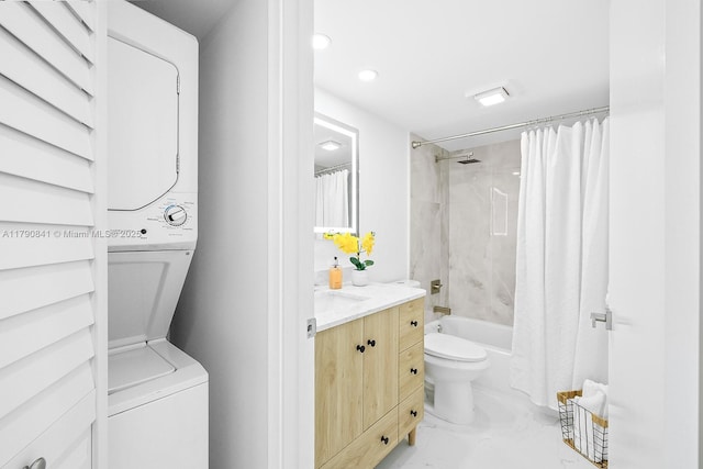 bathroom featuring vanity, toilet, recessed lighting, stacked washer / dryer, and shower / tub combo