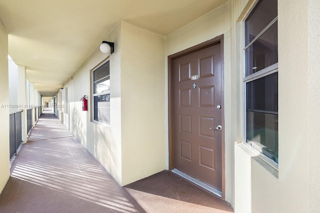 doorway to property featuring stucco siding