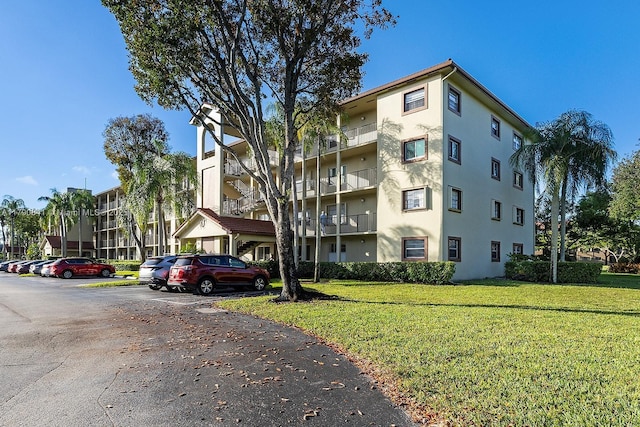 13000 SW 15th Ct Unit 310U, Pembroke Pines, FL 33027 - view of building exterior with uncovered parking