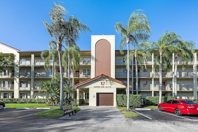 view of property featuring uncovered parking