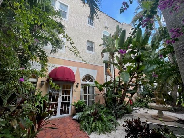 back of property featuring french doors and stucco siding