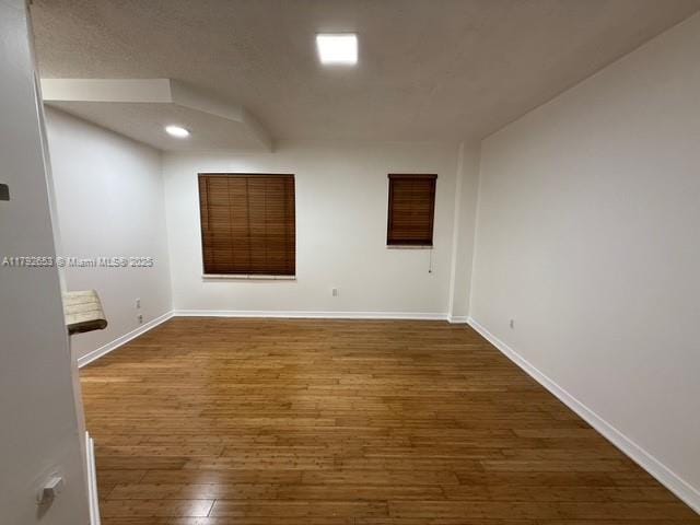 unfurnished room featuring baseboards, recessed lighting, and hardwood / wood-style floors