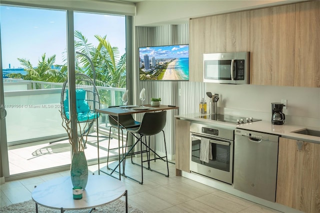 3900 Biscayne Blvd Unit N-723, Miami, FL 33137 - kitchen with appliances with stainless steel finishes, modern cabinets, light brown cabinetry, and light countertops