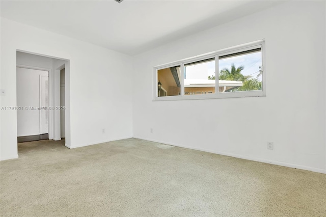 empty room featuring baseboards