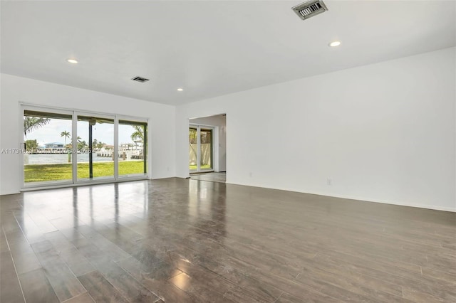unfurnished room featuring visible vents, recessed lighting, and wood finished floors
