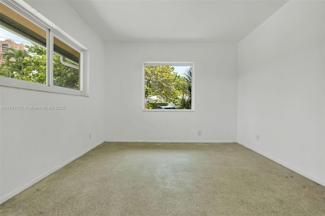 unfurnished room featuring baseboards