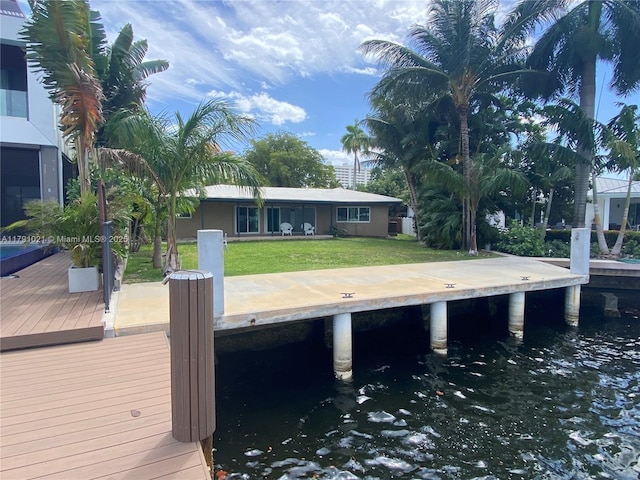 dock area with a water view and a yard