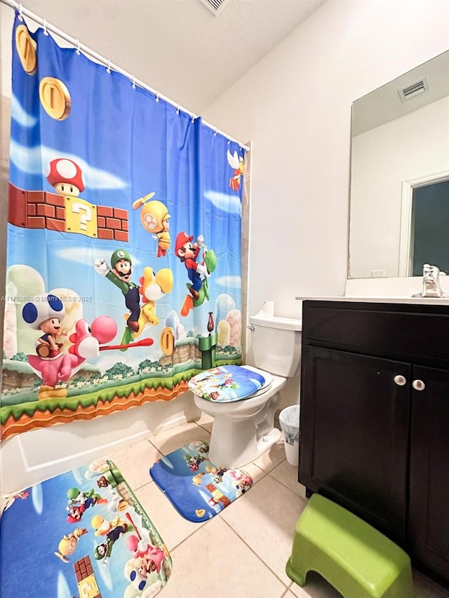 bathroom featuring toilet, tile patterned floors, visible vents, and vanity