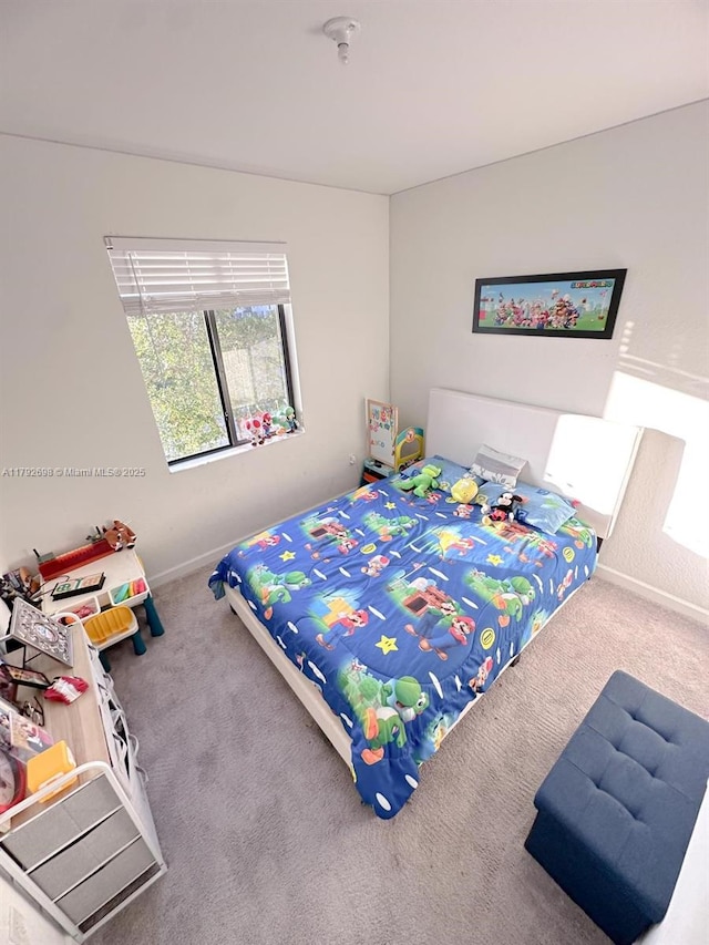 carpeted bedroom with baseboards