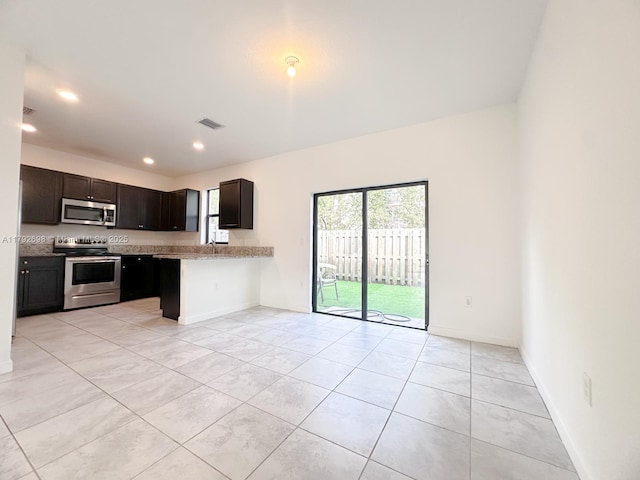 kitchen with visible vents, baseboards, light tile patterned floors, and stainless steel appliances