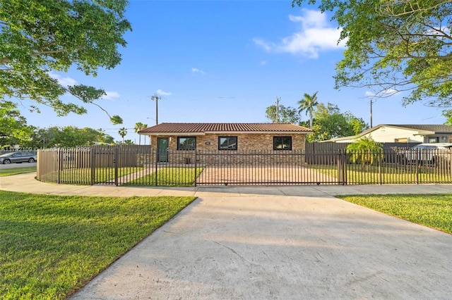 11981 SW 178th Ter, Miami, FL 33177 - view of front facade with concrete driveway, metal roof, and a front yard