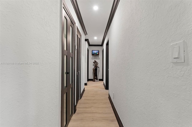 11981 SW 178th Ter, Miami, FL 33177 - hallway with a textured wall, ornamental molding, baseboards, and light wood finished floors