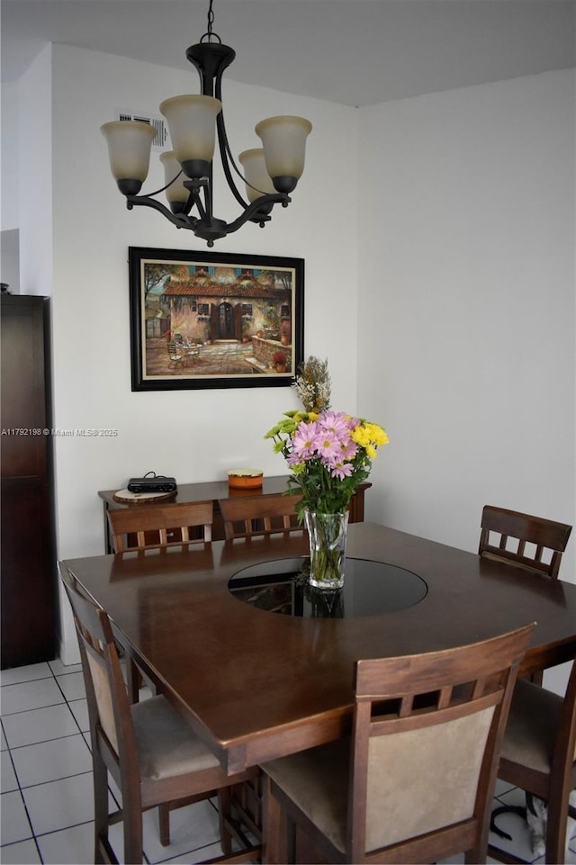 3240 W 70th St Unit 101, Hialeah, FL 33018 - dining area featuring an inviting chandelier, light tile patterned flooring, and visible vents