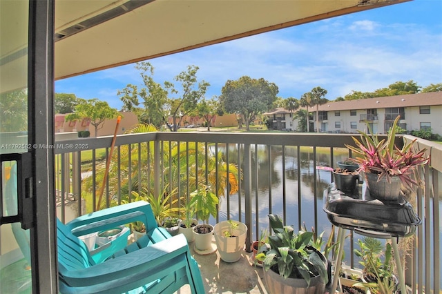 balcony featuring a water view and a residential view