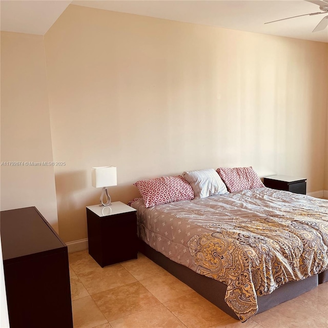 bedroom with baseboards and tile patterned flooring