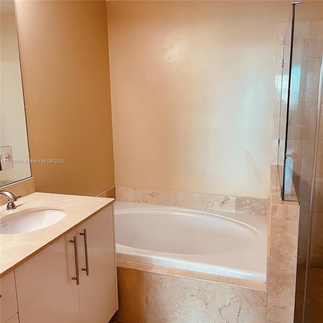 bathroom with vanity, a stall shower, and a bath