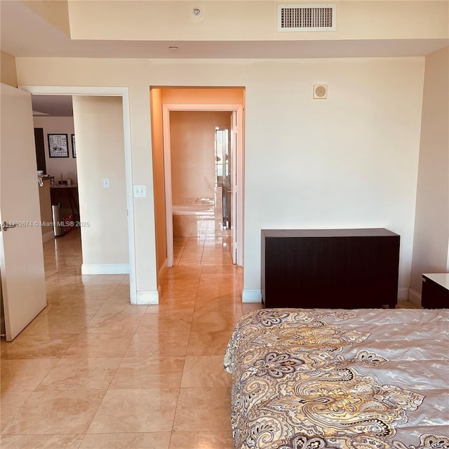 bedroom featuring baseboards and visible vents