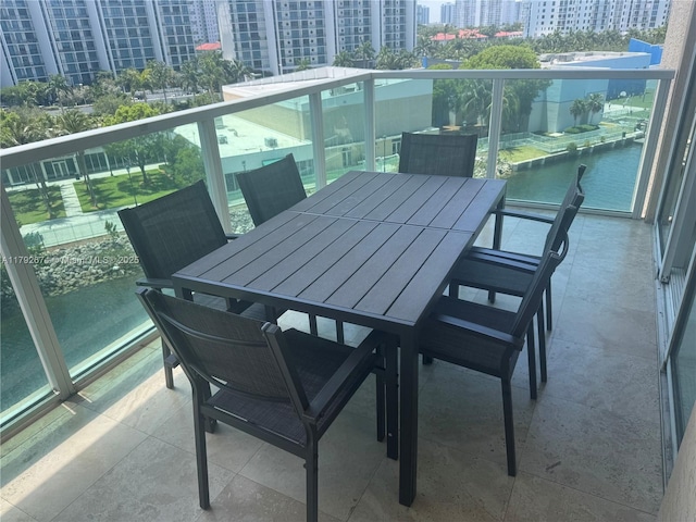 balcony with a view of city and outdoor dining area