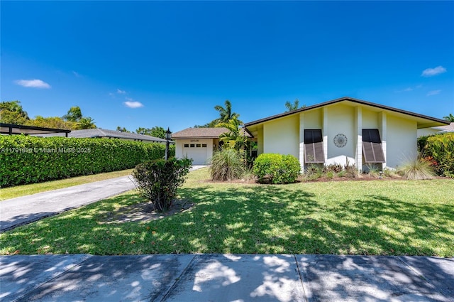 18525 SW 90th Ct, Cutler Bay, FL 33157 - view of front of home with concrete driveway, stucco siding, a front yard, and a garage