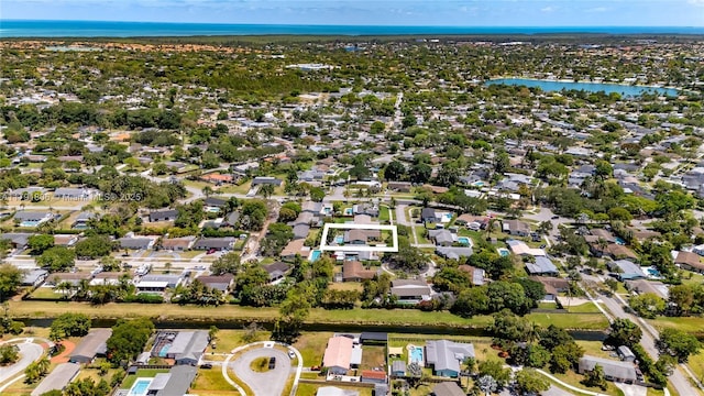 drone / aerial view featuring a water view and a residential view