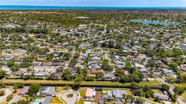 birds eye view of property with a water view and a residential view