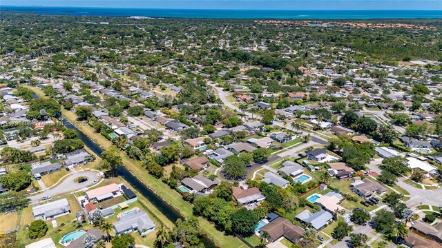 drone / aerial view with a water view and a residential view