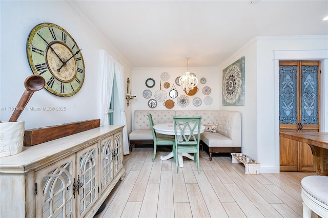 18525 SW 90th Ct, Cutler Bay, FL 33157 - dining area with light wood-type flooring, ornamental molding, breakfast area, and an inviting chandelier