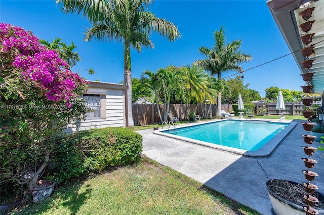 view of swimming pool with a fenced backyard, a fenced in pool, and a patio area