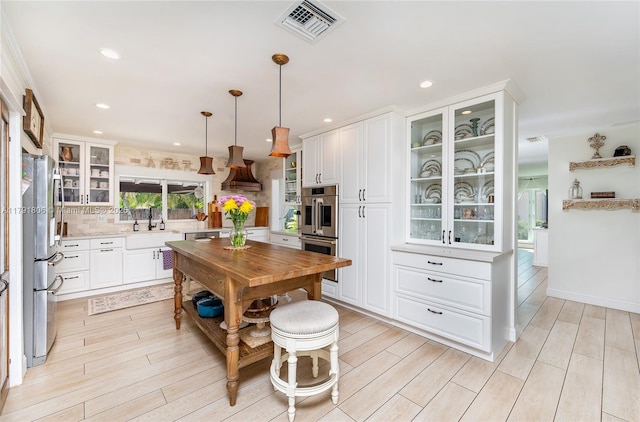 18525 SW 90th Ct, Cutler Bay, FL 33157 - kitchen with backsplash, stainless steel appliances, visible vents, and white cabinetry