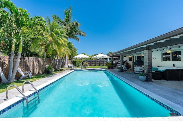 view of pool with a fenced in pool, a fenced backyard, a patio area, and an outdoor hangout area