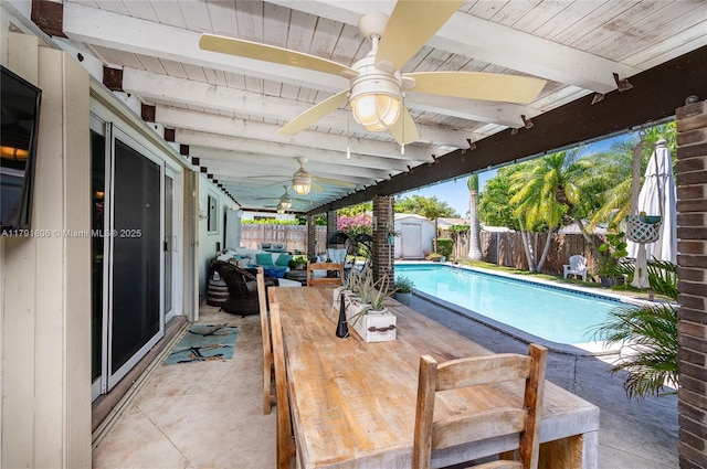 view of pool with ceiling fan, a patio, a fenced backyard, a storage shed, and an outbuilding