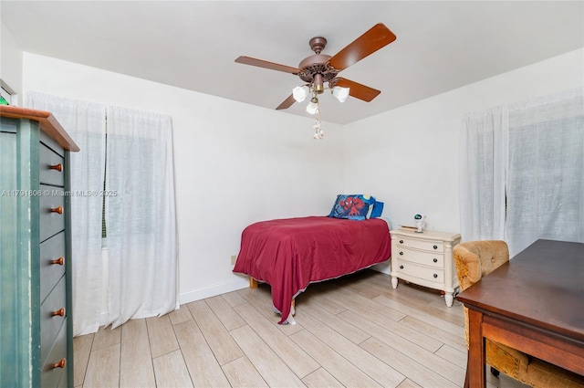 18525 SW 90th Ct, Cutler Bay, FL 33157 - bedroom featuring light wood-style floors, a ceiling fan, and baseboards