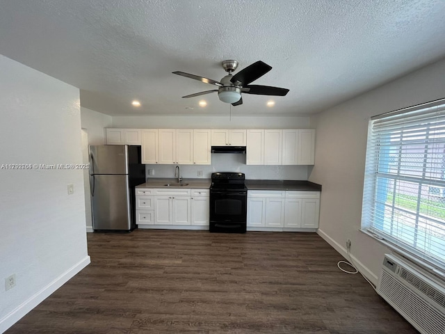 kitchen featuring white cabinets, ceiling fan, freestanding refrigerator, baseboards, and black range with electric cooktop