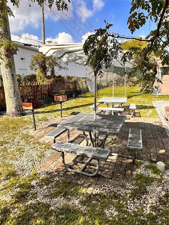 view of property's community with a patio, fence, and a yard