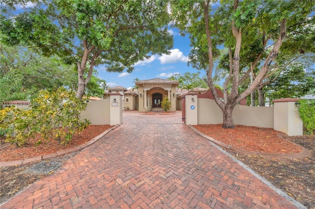 7761 SW 122nd Ave, Miami, FL 33183 - mediterranean / spanish house featuring stucco siding, a fenced front yard, a gate, and a tiled roof